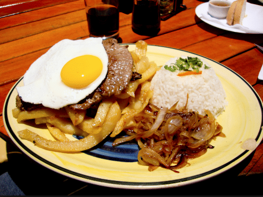 Bistec a lo pobre is a Chilean dish that combines a bunch of great foods we know and love